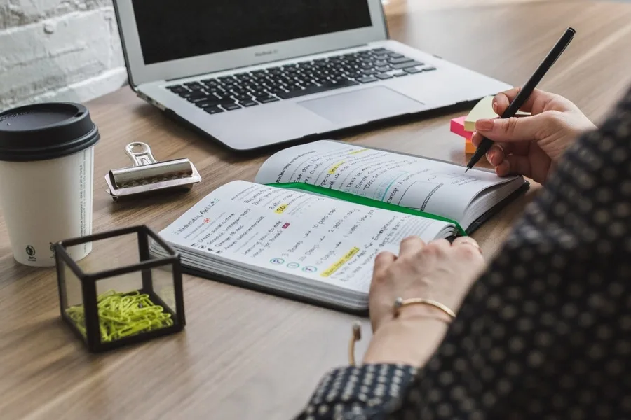 Notebook, laptop, and handwritten career planning notes