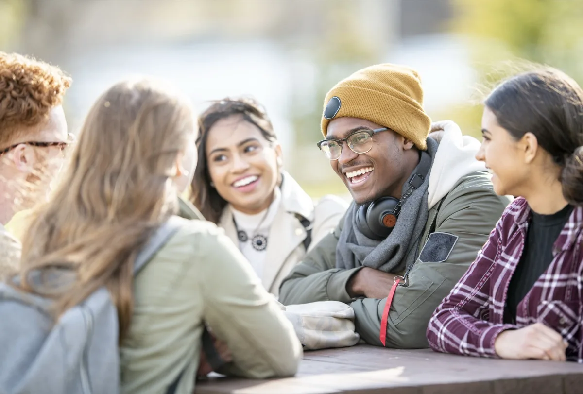 Diverse team discussion on future goals Students gathered outdoors discussing future goals